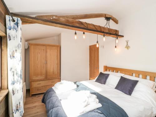 a bedroom with a large bed with white pillows at Deer Lodge in Wimborne Minster