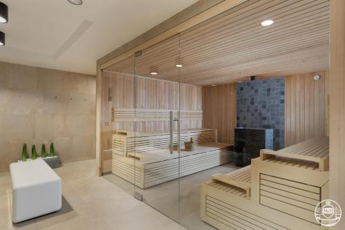 a room with a sauna with a glass wall at M&M-Spa&Art Bali, Nadmorskie Tarasy in Kołobrzeg