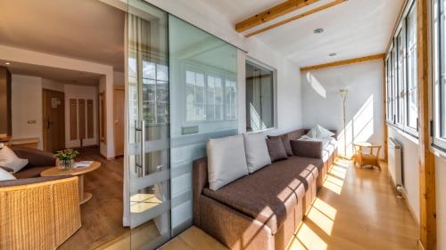 a living room with a couch and a table at Hotel Post - OlangCard included in Valdaora