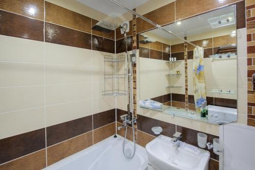 a bathroom with a sink and a toilet and a mirror at ОК! Усова, 25/1 №1 in Tomsk