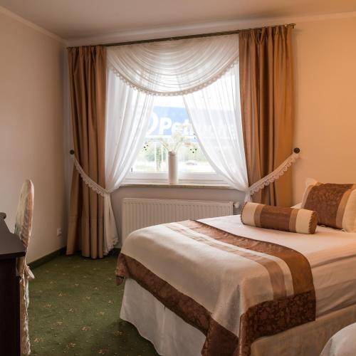 a bedroom with two beds and a window at Motel LESTA in Lachówka Duża
