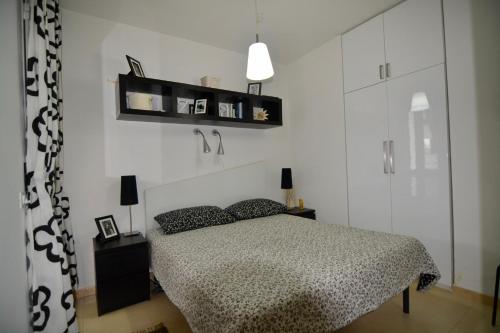 a bedroom with a bed and shelves on the wall at Terrazza Merope in Torre dell'Orso