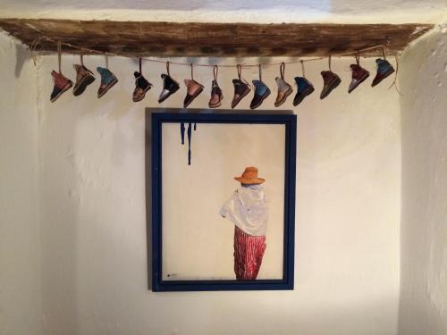 a picture of a man in a hat hanging on a wall at Casa Perleta in Chefchaouene