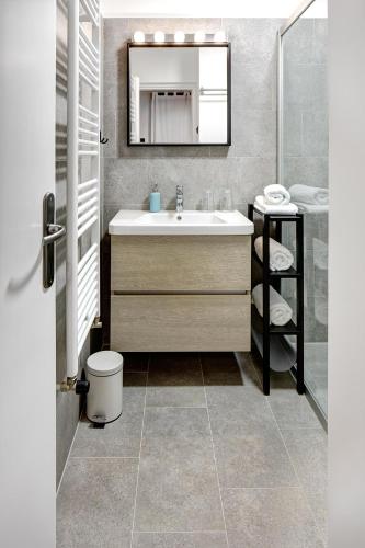 a bathroom with a sink and a mirror at Apartments Viola in Zagreb