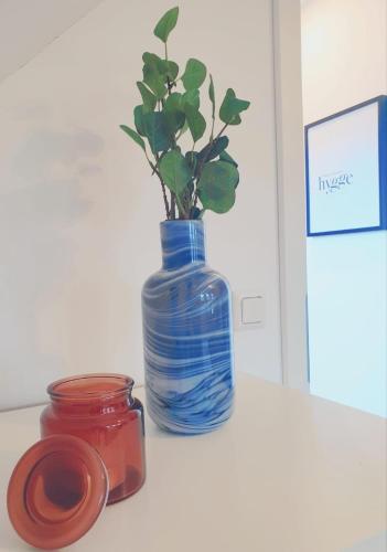 a blue vase with a plant in it on a table at Idylle pur in der Nähe der Autostadt in Oebisfelde