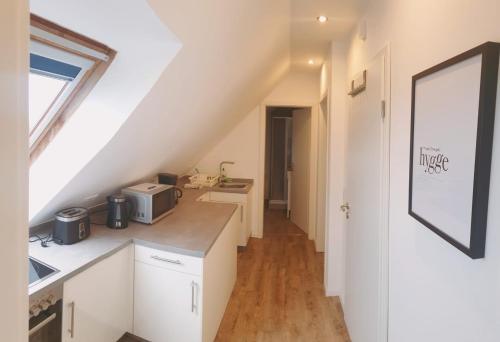 a kitchen with white cabinets and a counter top at Idylle pur in der Nähe der Autostadt in Oebisfelde