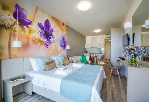 a bedroom with a large bed and a kitchen at Incognito Creta Luxury Suites and More in Kolymvari