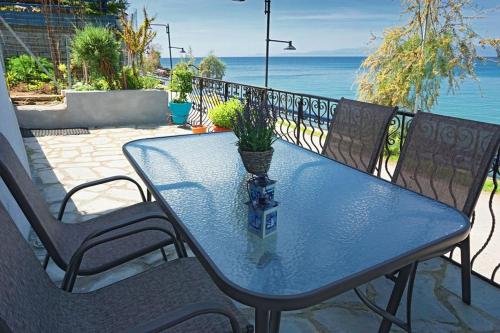 a blue table with a potted plant sitting on a patio at Ilio Socrates in Skala Marion