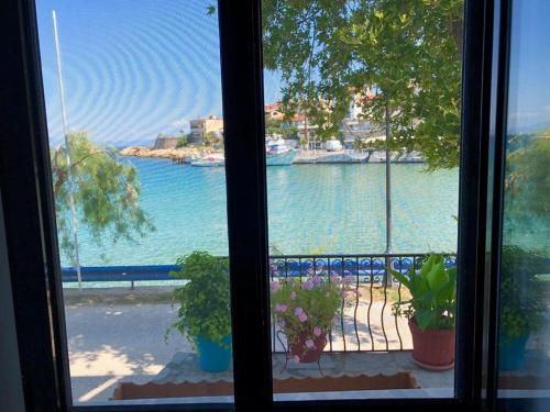 a window with a view of a body of water at Ilio Socrates in Skala Marion