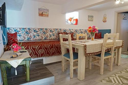 a living room with a table and chairs and a couch at Ilio Socrates in Skala Marion