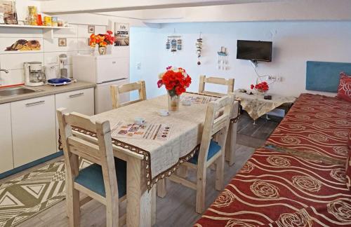 a kitchen with a table and chairs and a kitchen with a kitchen at Ilio Socrates in Skala Marion