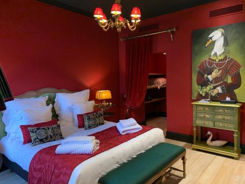 a bedroom with a king sized bed and a mirror at Le Prieuré de Boulogne in Tour-en-Sologne