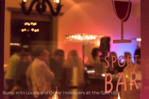 a group of people standing in a bar at Sporthotel Pontresina in Pontresina