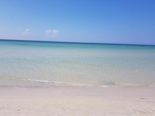 a sandy beach with the ocean in the background at Royal Thalassa Monastir in Monastir