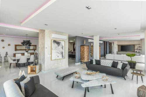 a living room with couches and a dining room at Serenity Hotel Boutique By Alsol in Playa del Carmen