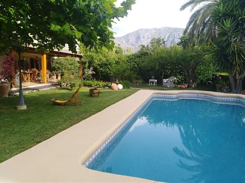 a swimming pool in the yard of a house at Casa la Gaspareta in Beniarbeig