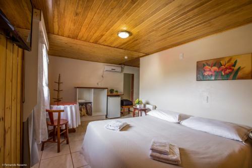 A bed or beds in a room at Urubici Park Hotel