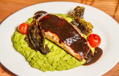 a plate of food with a piece of meat and vegetables at Best Western Patagonia in Puerto Natales