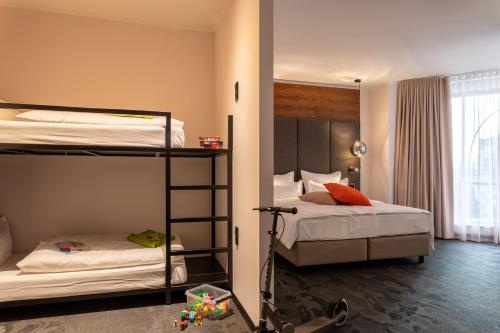 a bedroom with two bunk beds and a window at Hotel Neuer Fritz in Berlin