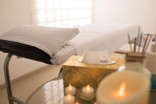 a bed room with a table with candles and a bed at Hotel Cortez in Santa Cruz de la Sierra