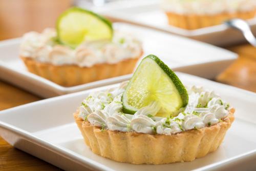 a lime tart on a white plate on a table at Hotel Cortez in Santa Cruz de la Sierra