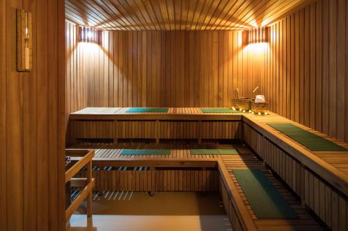 a sauna with wooden walls and floors and lights at Hotel Cortez in Santa Cruz de la Sierra
