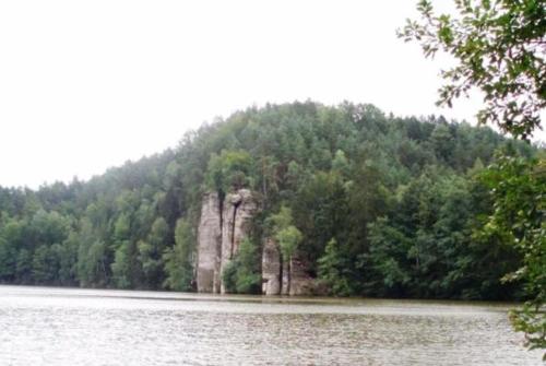 a mountain in the middle of a body of water at Roubenka Na Hrádku - Český ráj in Libošovice