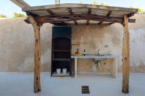 an outdoor kitchen with a counter and a sink at Villa Sa Rota Luxury Sea Views in San Antonio