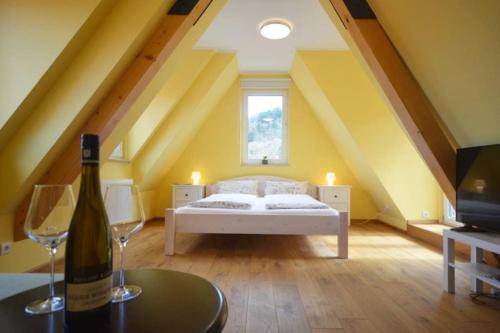 a bedroom with a bed and a bottle of wine at SO APARTMENTS am Marktplatz 4 in Weinheim