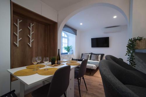 a dining room with a table with wine glasses at Pintes 38 in Dunaújváros