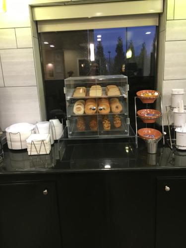 a counter with a bunch of donuts on display at La Quinta Inn & Suites by Wyndham Louisville East in Louisville