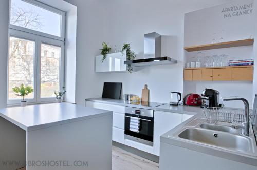 a kitchen with a sink, stove, and dishwasher at Apartament na Granicy / Apartment on the border in Cieszyn