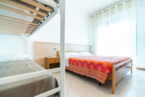 a bedroom with two beds in a room with a window at Residence Comfort in Lido di Jesolo