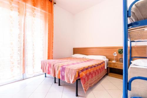 a bedroom with a bed and a window at Residence Comfort in Lido di Jesolo