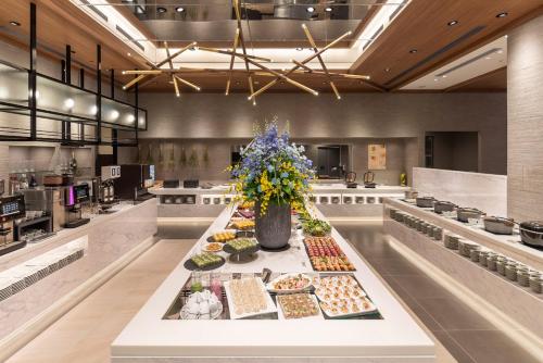 a buffet of food on a table in a kitchen at Royal Pines Hotel Urawa in Saitama