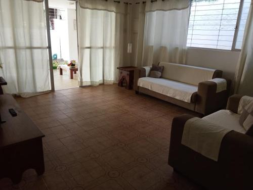 a living room with a couch and a table at Casa Rosarinho 1- RECIFE - Quartos com Banheiros Exclusivos in Recife