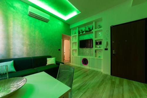 a green living room with a couch and a table at FASHION APARTMENT SILVER Bologna in Bologna