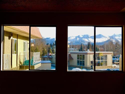 two windows of a house with a view of mountains at Americas Best Value Inn & Suites Anchorage Airport in Anchorage