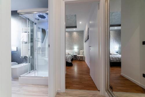 a bathroom with a shower and a bath tub at FASHION APARTMENT SILVER Bologna in Bologna
