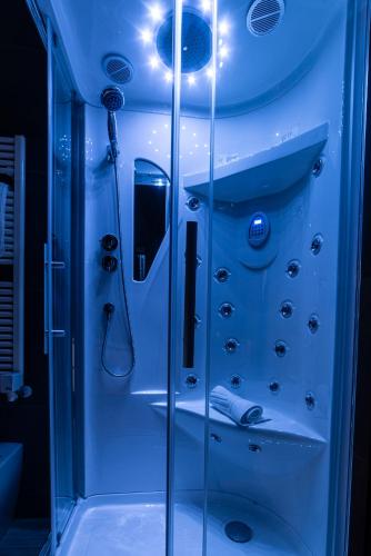 a bathroom with a shower with a glass door at FASHION APARTMENT SILVER Bologna in Bologna