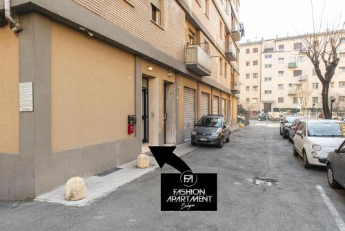 a street with cars parked on the side of a building at FASHION APARTMENT SILVER Bologna in Bologna