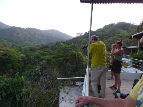 a man taking a picture of a group of people at Hostal Alto de la Montaña in Minca
