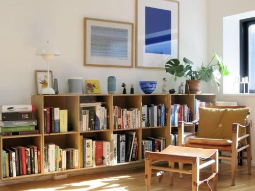 a book shelf filled with books in a living room at ApartmentInCopenhagen Apartment 1362 in Copenhagen
