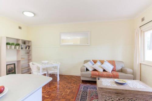 a living room with a couch and a table at B5 Crawley Apartment 1 BRM & Sleepout near UWA in Perth