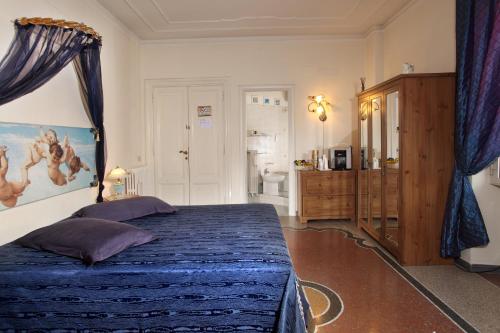 a bedroom with a bed with a blue comforter at B&B DolceVirginia in Rome