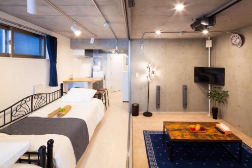 東京的住宿－Laffitte Hirai Condominium Hotel，客房设有两张床、一张桌子和一台电视机。