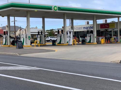 a gas station with aghostmite sign in front of it at Relax On Bingham in Goolwa