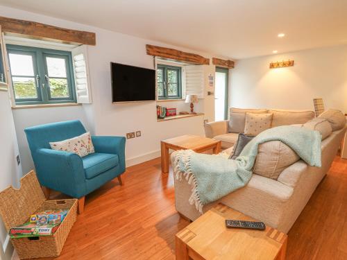 a living room with a couch and two chairs at Lantern Cottage in Padstow