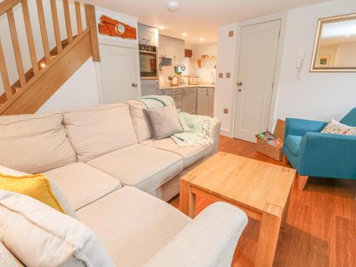a living room with a couch and a table at Lantern Cottage in Padstow