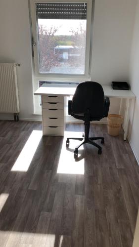 an office with a desk and a chair in front of a window at Hostel Nordkirchen by Frerichmann in Nordkirchen